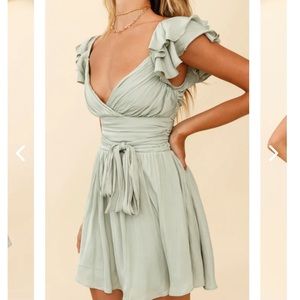 Pistachio dress with ruching and ruffle sleeves